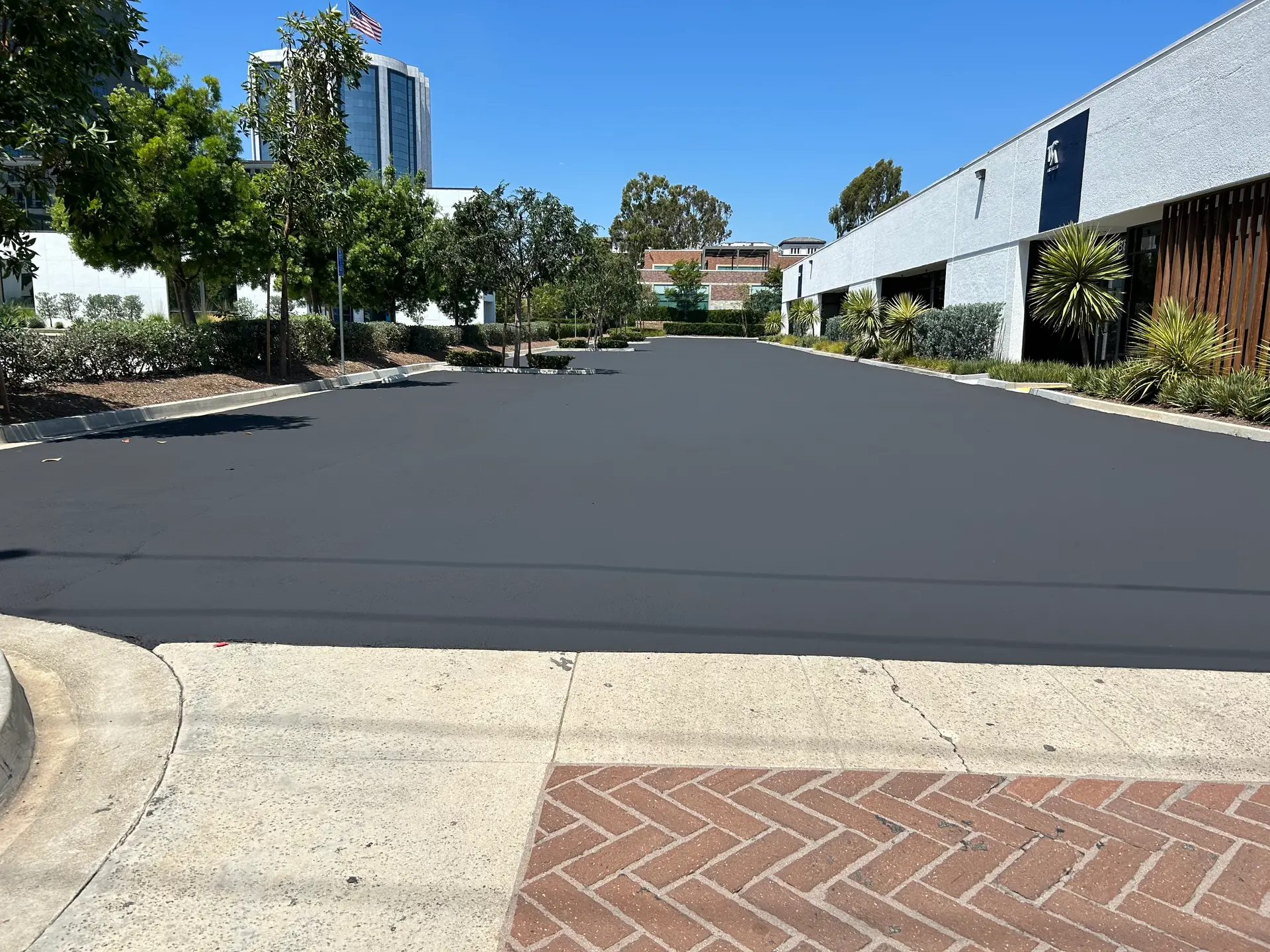 Freshly paved and sealed commercial parking lot in Southern California by Native Union Engineering